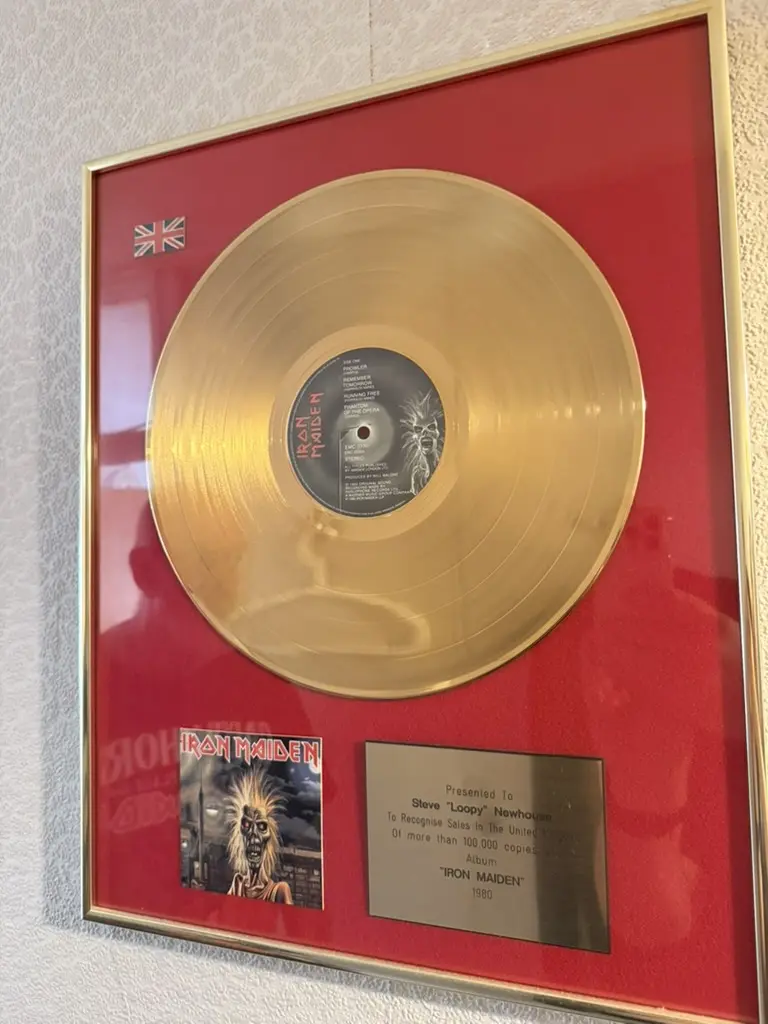 Gold disc presented to Steve Loopy Newhouse for sales of more than 100,000 copies of Iron Maiden's debut album